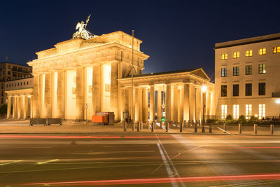 Statue in city at night