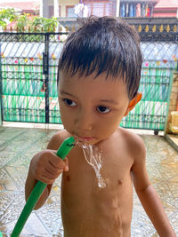 Portrait of cute boy drinking water