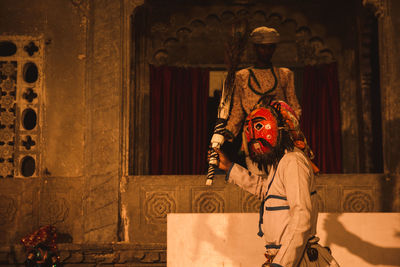 Man wearing mask during theatrical performance