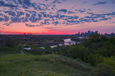 High angle view of trees and buildings against sky during sunset