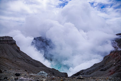 Heavy smoke comes from an active volcano crater of aso mountain in kyushu, japan