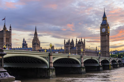 View of tower bridge over river in city against sky