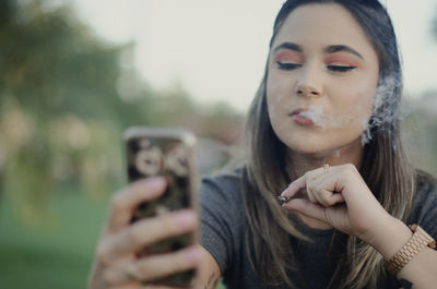 Portrait of young woman using mobile phone