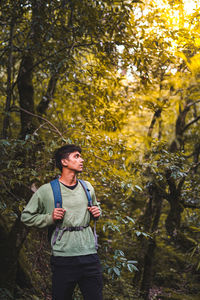 Young handsome asian boy exploring the jungle, travel and adventure.