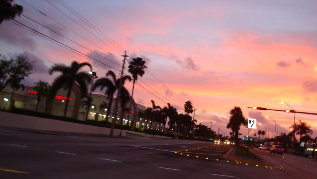 transportation, road, sunset, sky, street, tree, power line, silhouette, street light, land vehicle, car, cloud - sky, road marking, mode of transport, palm tree, motion, electricity pylon, cable, illuminated, dusk