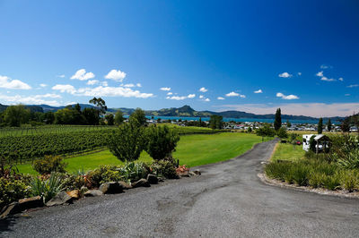 Road amidst field against sky
