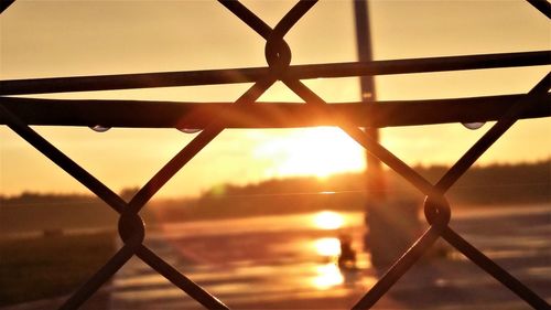 Close-up of silhouette metal against sky during sunset