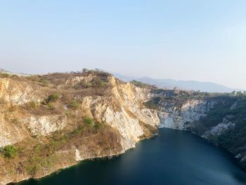 Scenic view of river amidst mountains against clear sky