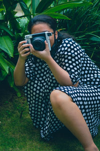 Portrait of woman photographing