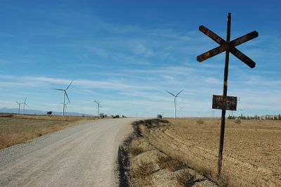 Road amidst field against sky