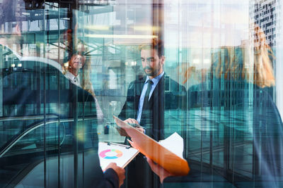 Digital composite image of man using mobile phone