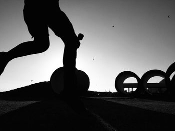 Low section of a silhouette man running on street