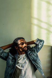 Portrait of young man looking at camera at home