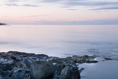 Scenic view of sea against cloudy sky