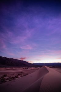 Scenic view of desert against sky during sunset