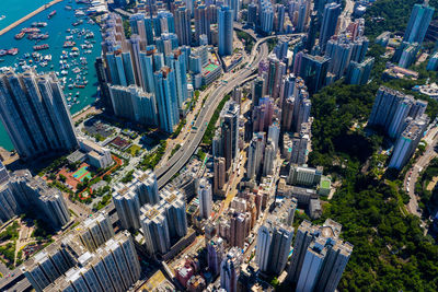 Aerial view of city by sea against sky