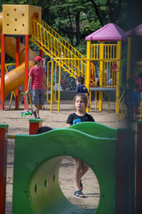 Children playing on slide at playground