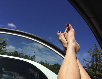 Low section of woman legs against sky