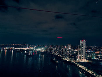 High angle view of illuminated city buildings at night