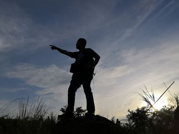 Low angle view of silhouette man standing against sky