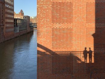 Reflection of building in river against sky