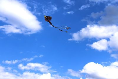 Low angle view of bird flying in sky