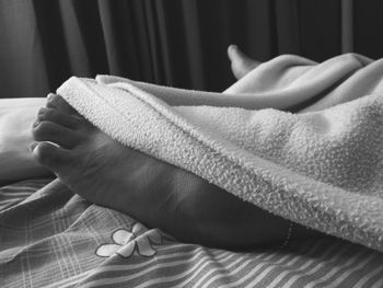 Close-up of baby hand on bed