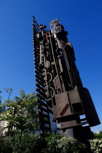 Low angle view of statue against blue sky