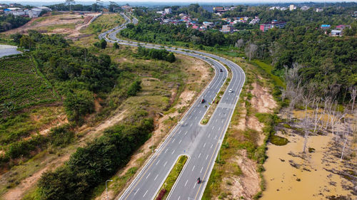 High angle view of road amidst trees in city