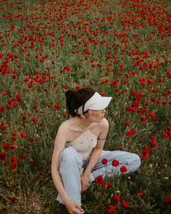 Young woman standing amidst flowers