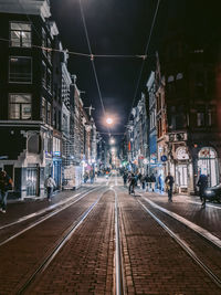 Illuminated city street at night