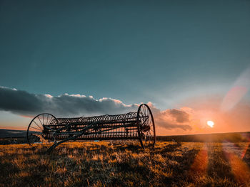 Scenic view of field against sky during sunset