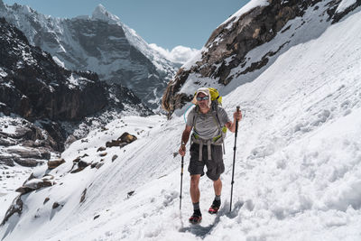 Full length of person on snowcapped mountain