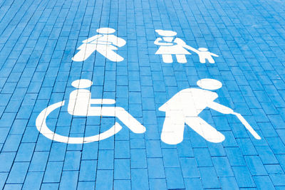 Handicapped parking spot, mom with child, elderly person and man with plaster. 