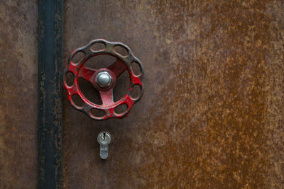 Close-up view of red doorknob