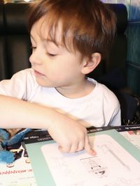 Portrait of cute boy sitting on table