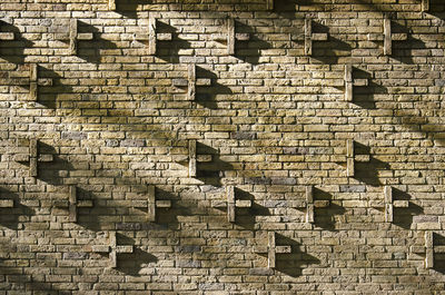 Sunlight and shadow on the ornamental masonry of a facade of a school buidling