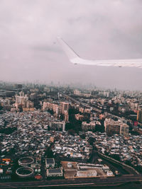 Aerial view of city and buildings against sky