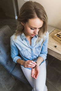 High angle view of woman sitting at home