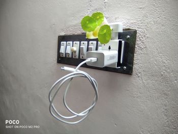 Close-up of telephone on table against wall