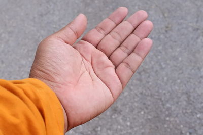 Cropped hand of person on street