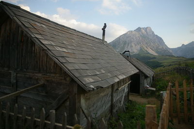 View of cottage on field against sky