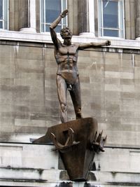 Statue against building in city