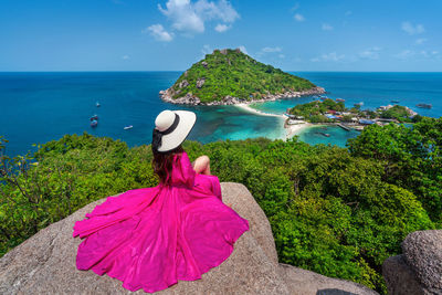 Rear view of woman looking at sea against sky