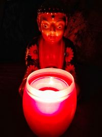 Close-up of red candle on table