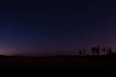 Scenic view of silhouette landscape against sky at night