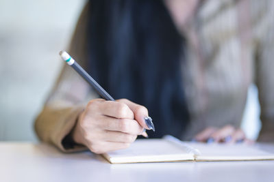 Close-up of woman hand holding book