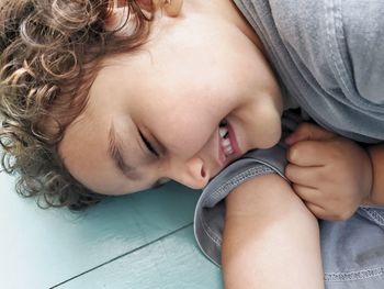 Cute smiling girl lying on floor