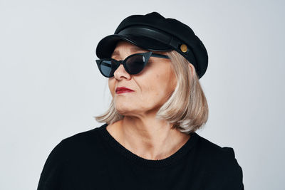 Portrait of woman wearing hat against white background