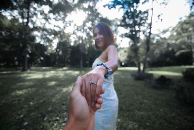 Midsection of woman holding umbrella while standing on land